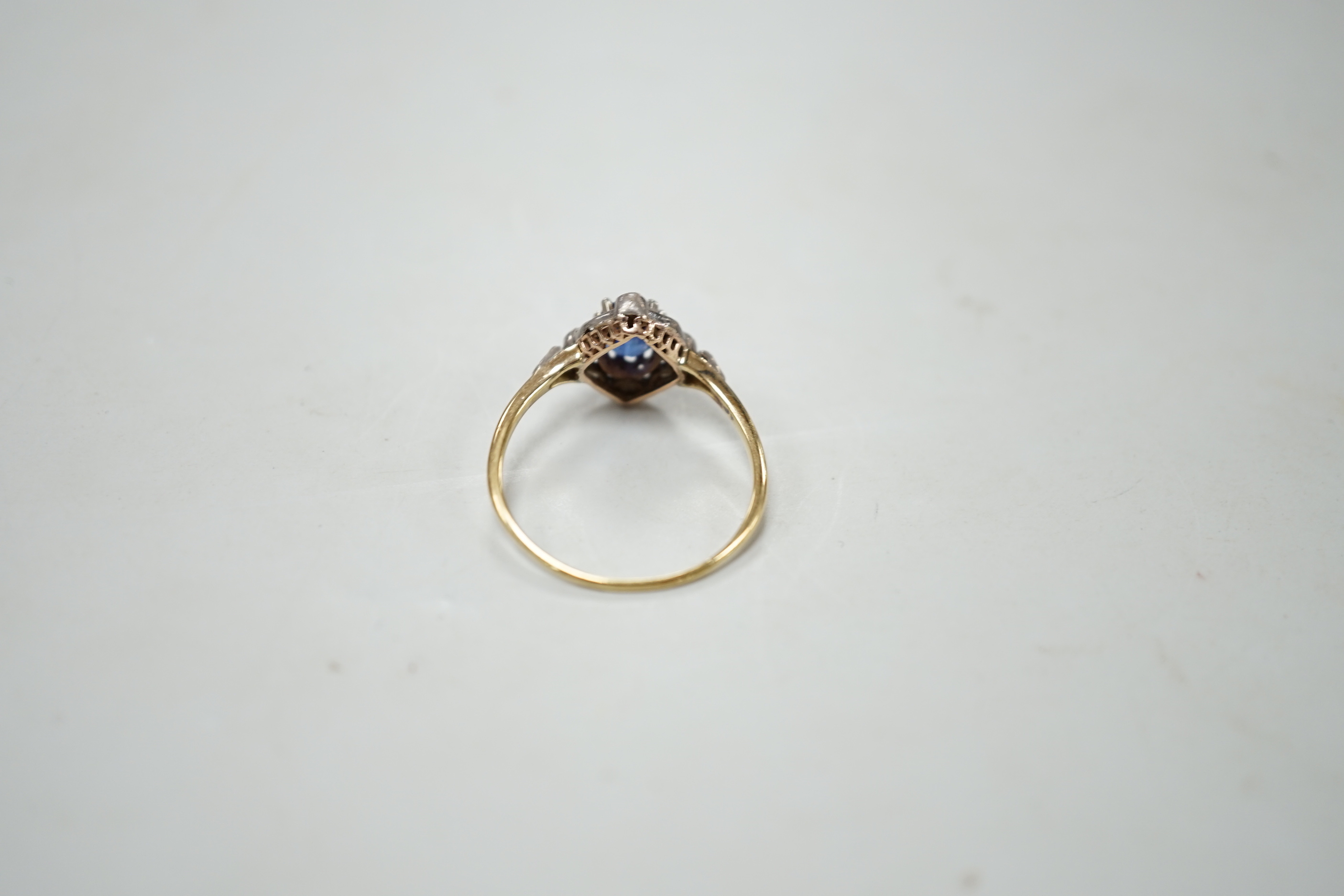 An early 20th century yellow metal, sapphire and diamond cluster set oval cluster ring, size R/S, gross weight 2.1 grams.